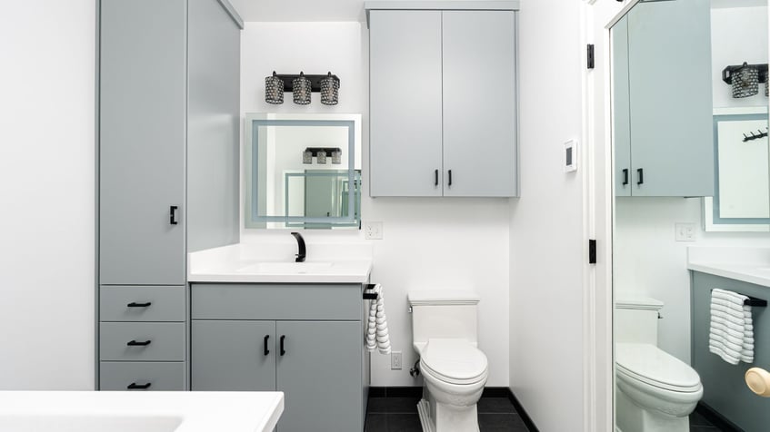 white bathroom with blue cabinetry by kraft custom construction in salem or