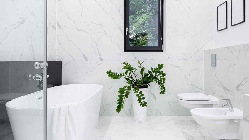 all white marbled bathroom with modern futuristic sink and toilet