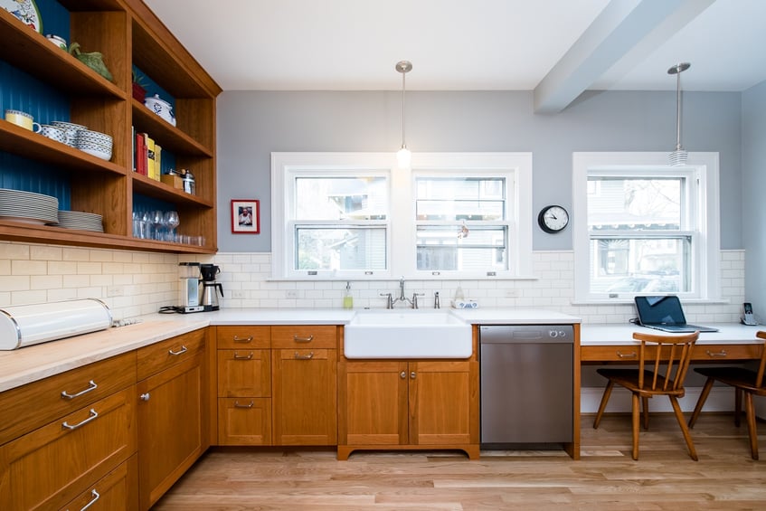 remodeled kitchen with wood cabinets and white sink by Kraft Custom Construction in Salem, OR