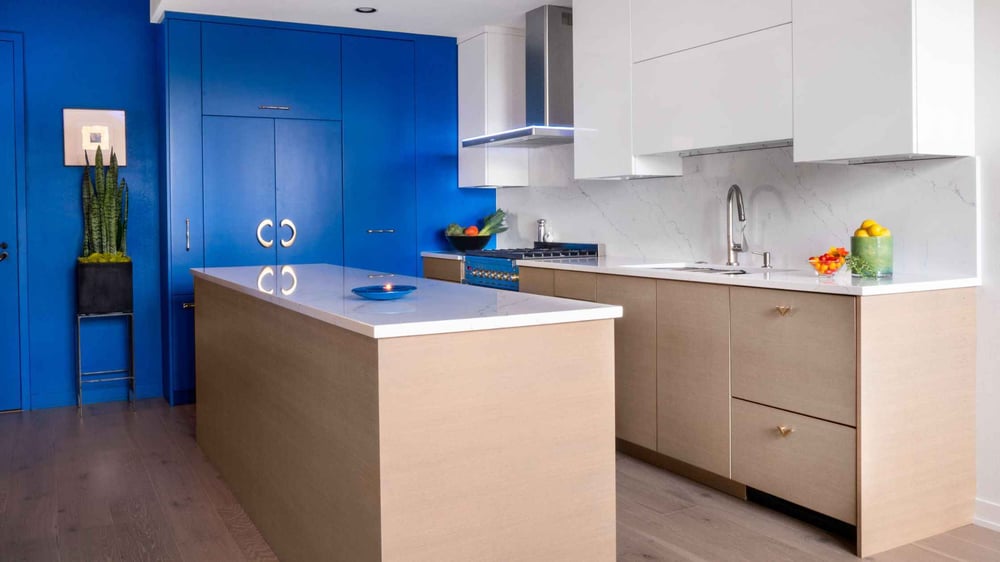 modern kitchen with white countertops and blue accent wall by Kraft Custom Construction in Salem, OR