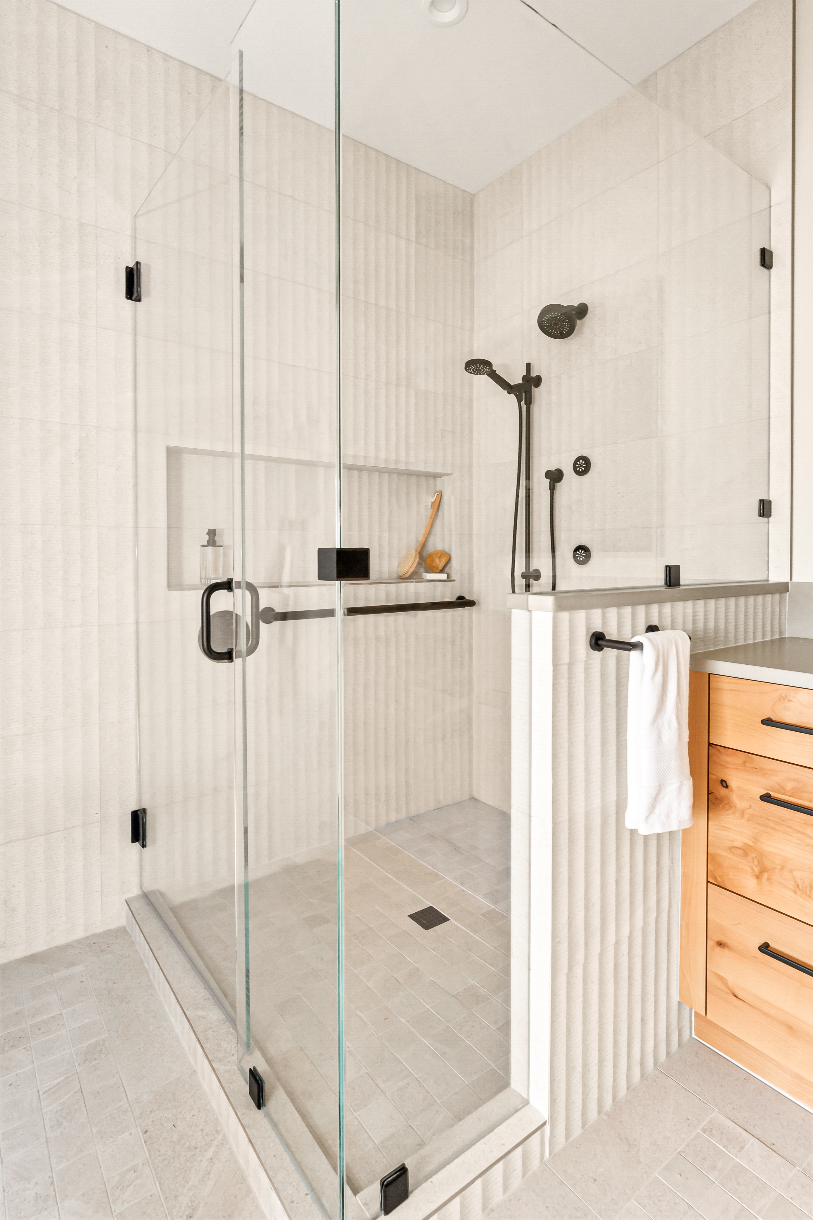 Modern and Minimal Shower With Porcelain Tile and Glass Partitions