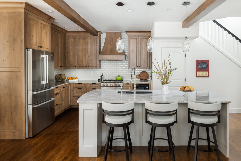interior of French-Country Kitchen Remodel with white stools in Tualatin, Oregon by Kraft Custom Construction