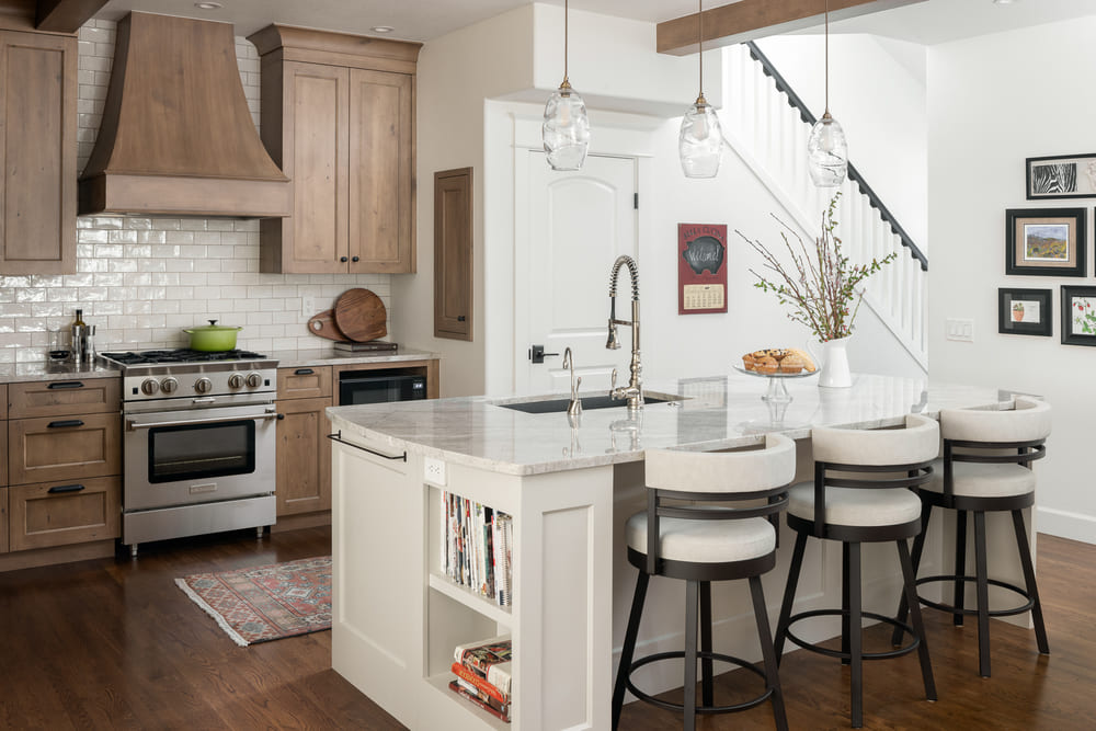 interior of French-Country Kitchen Remodel with white stools in Tualatin, Oregon by Kraft Custom Construction