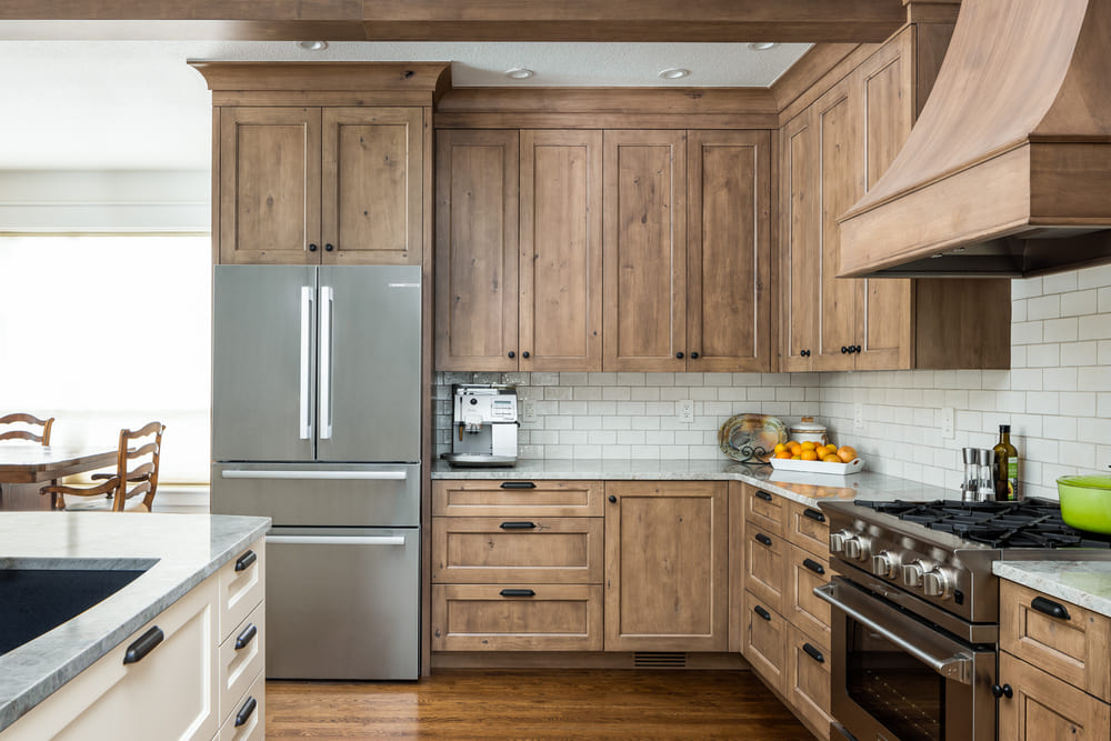 interior of French-Country Kitchen Remodel with wood finishes in Tualatin, Oregon by Kraft Custom Construction