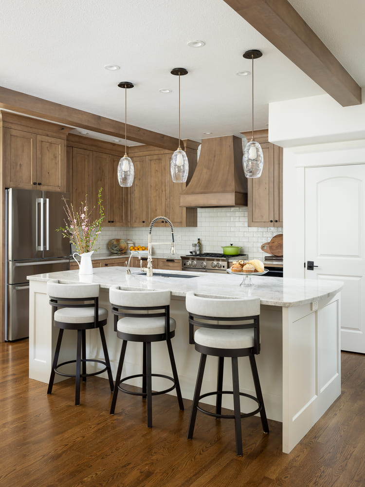 interior of French-Country Kitchen Remodel with white stools in Tualatin, Oregon by Kraft Custom Construction