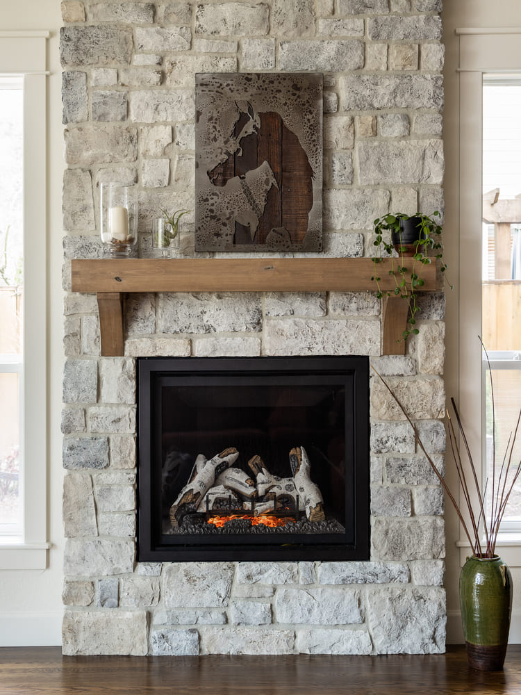 interior of French-Country Kitchen Remodel with stone fireplace in Tualatin, Oregon by Kraft Custom Construction